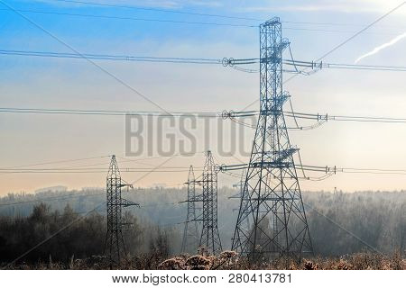 A Transmission Tower Or Electricity Pylon With Blue Sky. It Is A Tall Structure, Usually A Steel Lat
