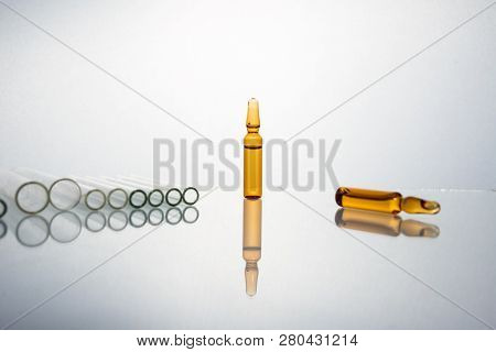 Group Of Vials With Medication On Blue Methacrylate Table. Horizontal Composition.