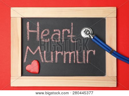 Blackboard With Text Heart Murmur And Stethoscope On Color Background, Top View