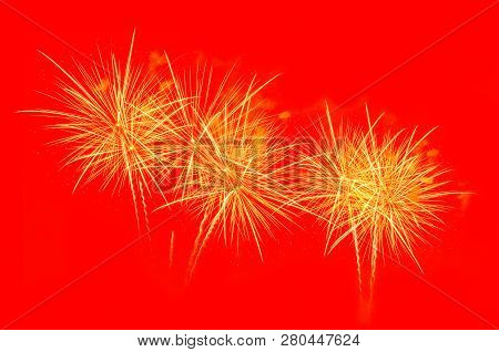 Golden Fireworks Celebration On Bright Red Background.