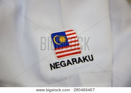 Close-up Of Embroidery Malaysia Logo With Wording Negaraku (my Country) On White Uniform