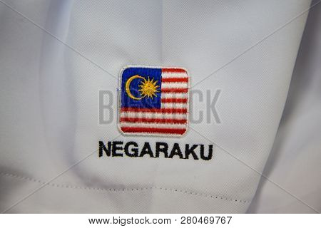 Close-up Of Embroidery Malaysia Logo With Wording Negaraku (my Country) On White Uniform
