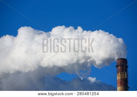 White Smoke Comes From Pipes Against Blue Sky. Problem Harmful Emissions And Air Pollution Of Centra