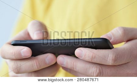 Close-up Of Hands Holding Smartphone, Typing Text On Touch Screen And Using Applications. A Person T