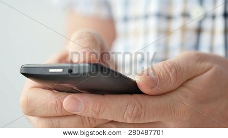 Close-up Of Hands Holding Smartphone, Typing Text On Touch Screen And Using Applications. A Person T