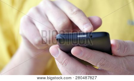 Close-up Of Hands Holding Smartphone, Typing Text On Touch Screen And Using Applications. A Person T