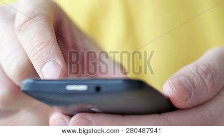 Close-up Of Hands Holding Smartphone, Typing Text On Touch Screen And Using Applications. A Person T
