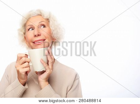 lifestyle  and people concept: old excited lady smiling laughing, holding cup drinking coffee, tea, beverage on white  background