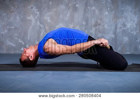 Young Man Performing A Yoga Pose Matsyasana