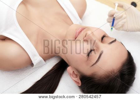 Beautiful Woman Getting Lifting Botox Injection In Forehead. Close-up Woman Hyaluronic Acid Injectio