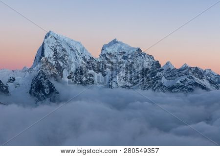 Dramatic Snowy Peak Of Mount Cholatse Rising Above Field Of Clouds. Picturesque Mountain Valley Fill