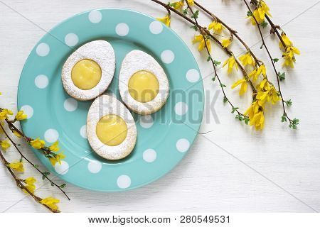 Homemade Easter Lemon Cookies And Forsythia Blooming Twigs On A Light Background.