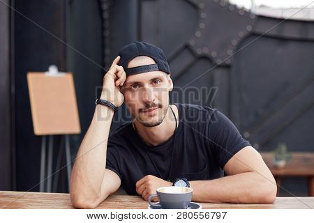 Handsome Confident Serious Young Caucasian Bearded Stylish Hipster Male,posing At Camera While Enjoy