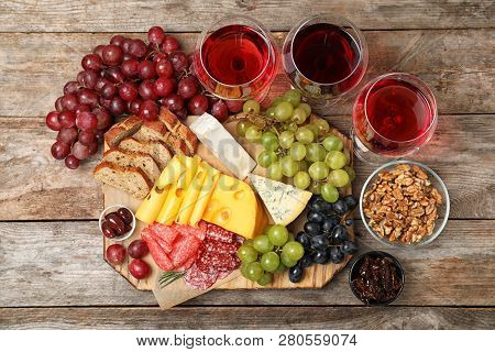 Flat Lay Composition With Wine And Snacks On Wooden Background