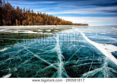 Frozen Lake Khubsugul. Beautiful Forest Near The Ice Surface On A Frosty Day. Natural Background