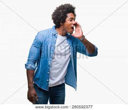 Afro american man over isolated background shouting and screaming loud to side with hand on mouth. Communication concept.