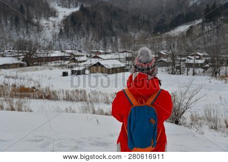 Woman Walking At Snow Village In Mohe County, Heilongjiang Province, China.