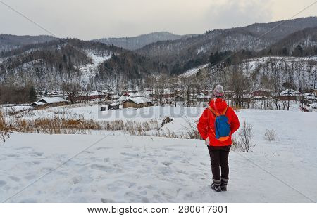 Woman Walking At Snow Village In China