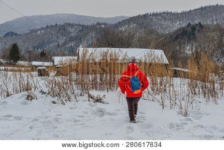 Woman Walking At Snow Village In China