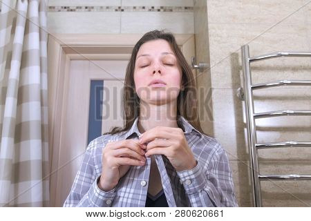 Sleepy Woman Who Has Just Woken Up With A Hangover In The Bathroom Fastens Her Shirt And Puts Hersel