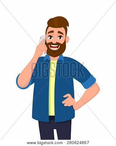 Happy Young Man Is Speaking On The Mobile Phone. Handsome Man With Beard Talking On Cell Phone Or Sm