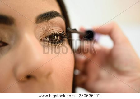 Make-up Artist Putting On The Eyelashes Of An African Woman