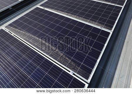 Dirty Dusty Photovoltaic Panels On Roof Caused By Dust Accumulated At The Low Side Of The Solar Pane