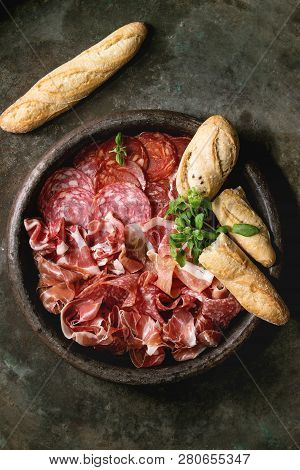 Antipasto Meat Platter Assorti Of Sliced Jamon, Salami, Chorizo Sausage In Terracotta Tray With Brea