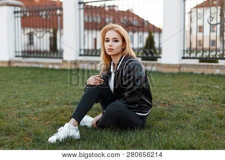 Young Attractive Fashionable Woman In A Stylish Light Jacket In A Polo Shirt In Stylish Jeans In Whi