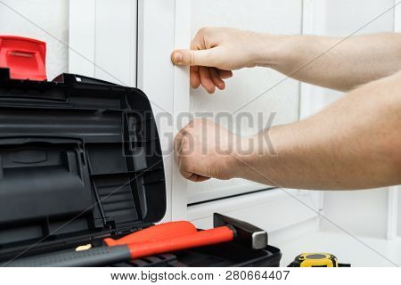 Man Installing Cassette Roller Blinds On Windows