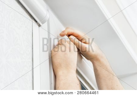 Man Installing Cassette Roller Blinds On Windows