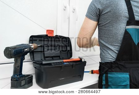 Man Installing Cassette Roller Blinds On Windows