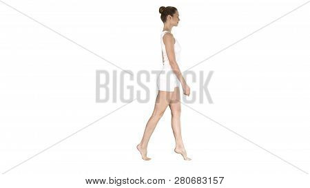 The Young Woman Walking On Her Tip-toes On White Background.