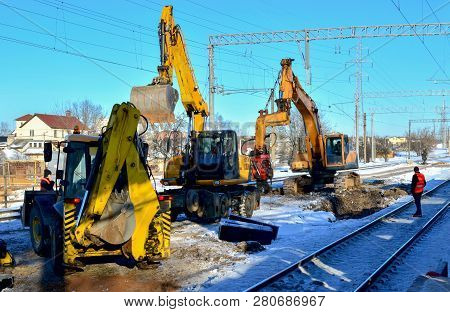 Preparing The Surface Of The Earth For Laying Railways. Excavator Digging Trenches For Laying Commun