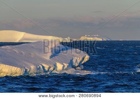 Antarctic Sunset: Floating Icebergs In The Weddell Sea, Near The Antarctic Peninsula, As Seen From A