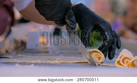 Chef Cooking Asian Natural Stir-fried Ice Cream Rolls At Freeze Pan. Outdoor Cooking, Gastronomy And