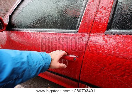 Transportation, Winter, Weather, Vehicle Concept. Hand On Car's Door Handle Covered In Snow And Icy 