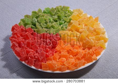 Pineapple Slices On The Plate. Four Colours Separately. Candied Fruit.