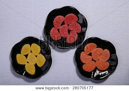 Plates With Sweets. Marmalade On The Dish. Black Dishes. Marmalade Slices.