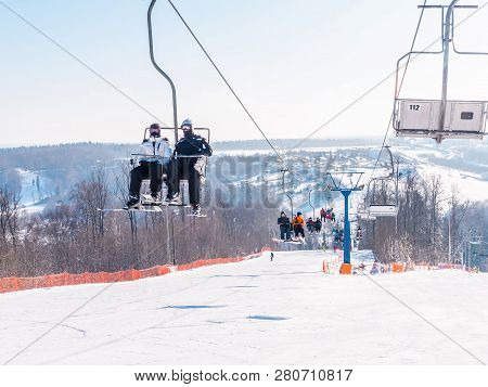 Skiers And Snouborders On A Ski Lift Pov In Winter Time. The Cable Car Lifts The Peoples Up To The S