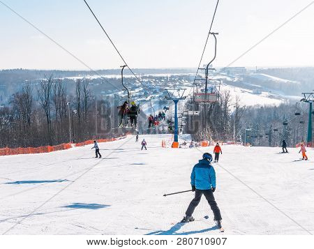 Skiers And Snouborders On A Ski Lift Pov In Winter Time. The Cable Car Lifts The Peoples Up To The S