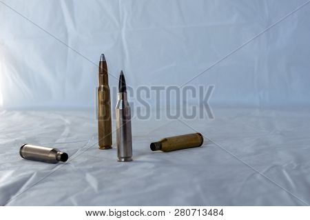 Bullets Ready To Be Fired And Casings Ready To Be Reloaded. Bokeh Effect.