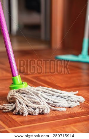 Rope Mop For Cleaning The Floor Is On The Floor Of The Tile.