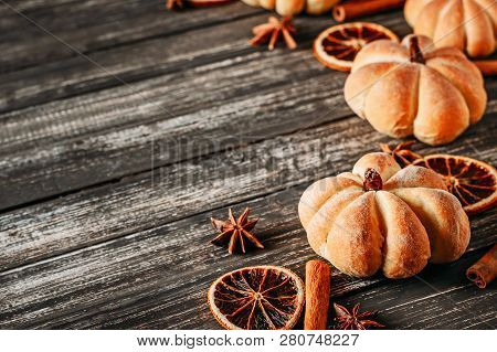 Homemade Cakes In Shape Of Pumpkin And Dried Oranges On Dark Wooden Backgroundm Top View With Copy S