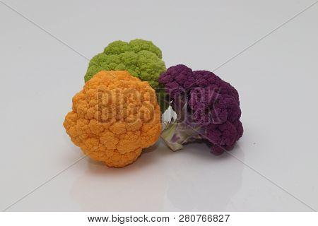Colorful Cauliflower Group On Orange Green And Purple Whiter Background