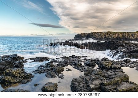 This Is A Picture Of A Rough Sea Smashing Up On To A Rocky Coast