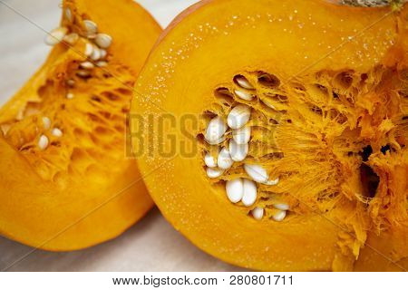 Tasty, Healthy And Fleshy Vegetable - Juicy, Bright Orange Pumpkin In A Cut With Seeds In Close-up, 