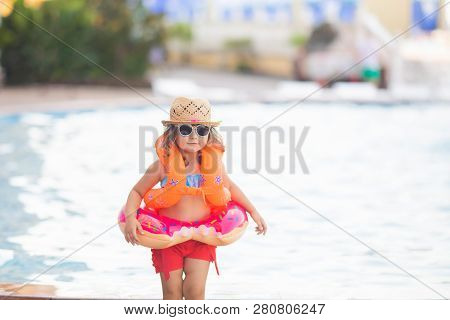 Adorable Little Girl Wearing Sunglasses, Inflatable Over-sleeves Floats And Inflatable Donut Float R