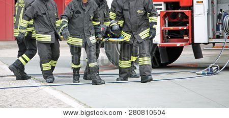 Vicenza, Vi, Italy - May 10, 2018: Italian Stretcher Bearers Firemen Transport An Injured On The Str