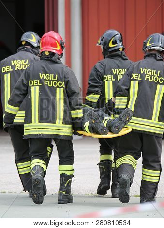 Vicenza, Vi, Italy - May 10, 2018: Stretcher Bearers Firefighters Transport An Injured On The Stretc